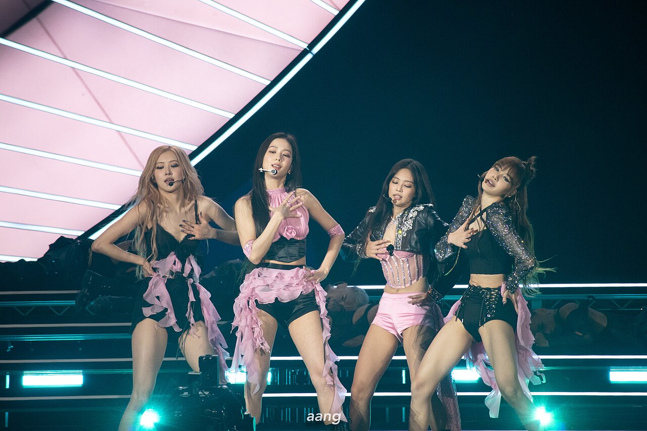 BLACKPINK performing onstage at Coachella on April 15, 2023, in pink and black outfits.